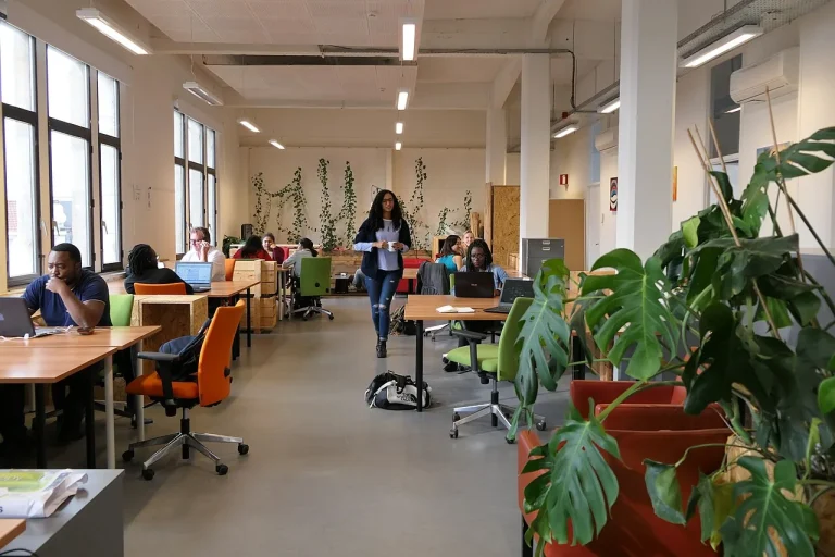 People working at shared desks in an open coworking space